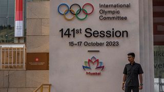 A security guard stands at the entrance of a venue ahead of the 141st International Olympic Committee (IOC) session in Mumbai, India.