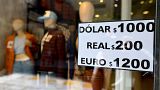 A sign with exchange currency values of the unofficial so-called "Blue Dollar" of the parallel market is displayed in the window of a store in Buenos Aires on October 10, 2023