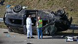 Police officers work at an accident site near an overturned mini bus on the motorway near Waldkraiburg in south, eastern Germany in October 13, 2023. 
