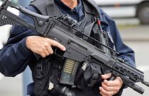 A police officer holds a HK G36 assault rifle at the Gambetta high school in Arras, northeastern France, Friday Oct. 13, 2023. 