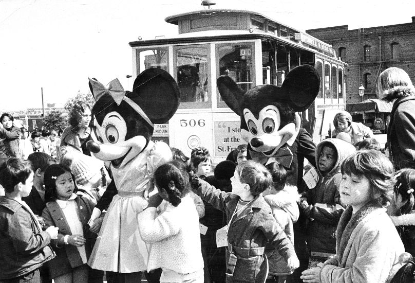 Mickey and Minnie Mouse visit school children in San Francisco. March 16, 1973.
