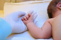 Baby in a hospital bed.