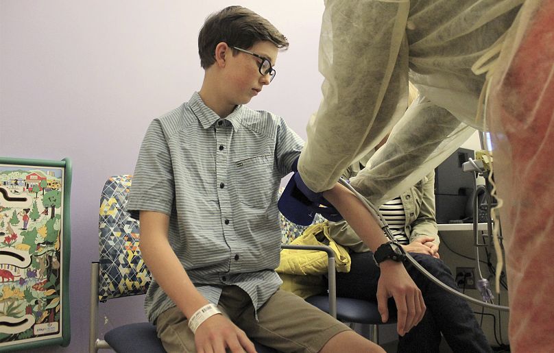 A young boy receives a health check.