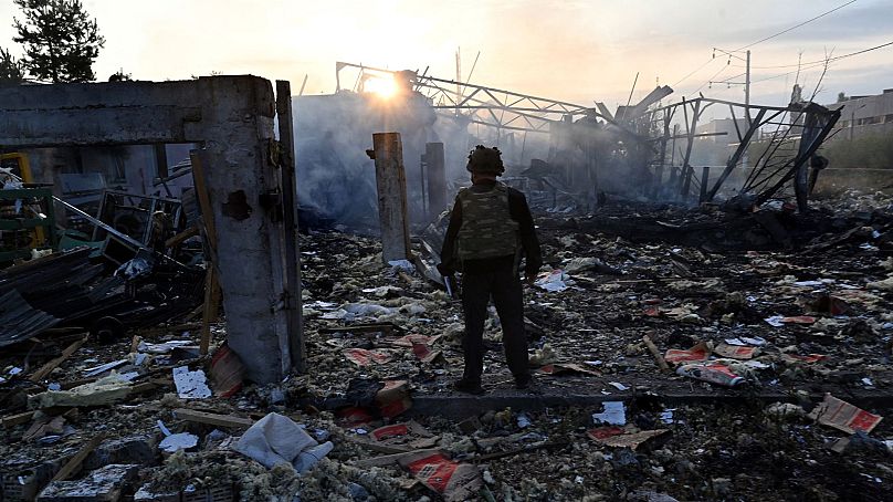 Police expert look at damages on an industrial area in the Ukrainian capital of Kyiv, after a massive overnight missile attack to Ukraine on September 21, 2023.