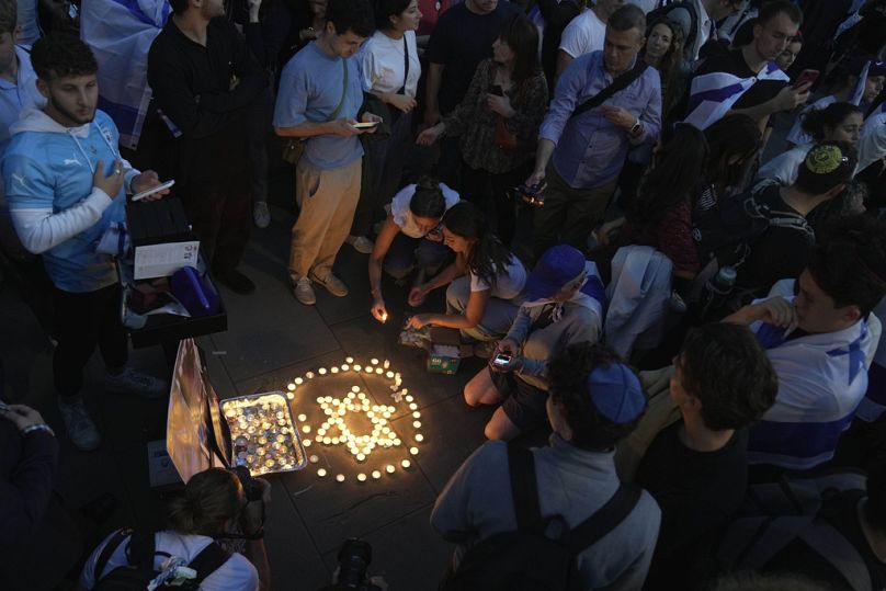 People light candles during the 'Jewish Community Vigil' for Israel in London, Monday, Oct. 9.