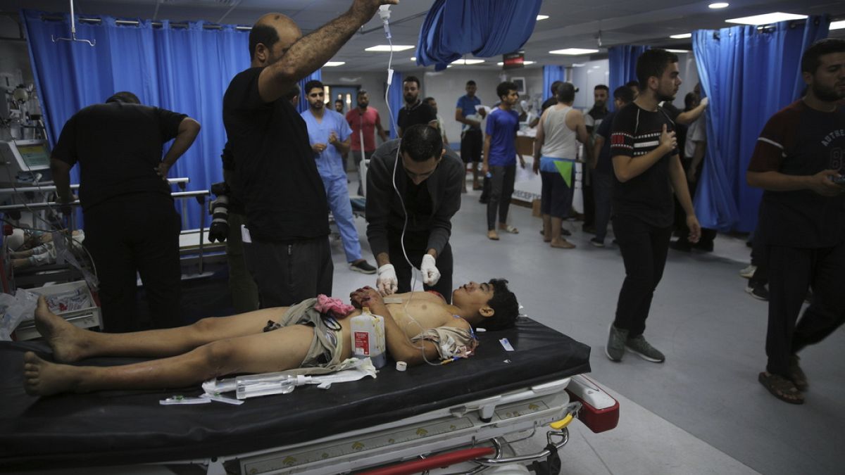 A Palestinian youth wounded in Israeli strikes is treated at Shifa Hospital in Gaza City, Friday, Oct. 13, 2023.