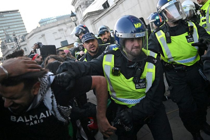 Des policiers aux prises avec des manifestants à Trafalgar Square après une "Marche pour la Palestine", à Londres, samedi 14 octobre 2023