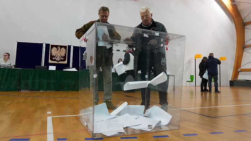 Residents take part in parliamentary elections in Warsaw, Poland, Sunday