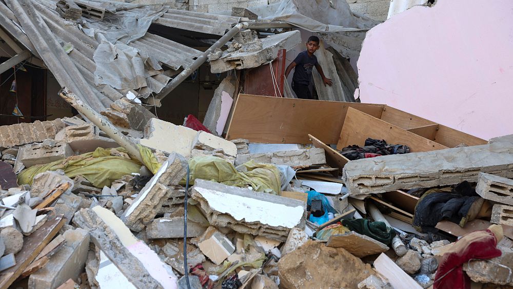 Палестинско момче гледа щетите докато стои върху развалините след израелски
