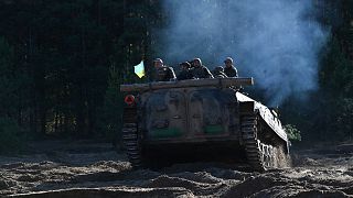 Servicemen of Ukrainian first presidential brigade "Bureviy" ride an armoured personnel carrier 