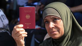 Palestinian woman shows her German passport at the Rafah border crossing between the Gaza Strip and Egypt Gaza Strip on Saturday