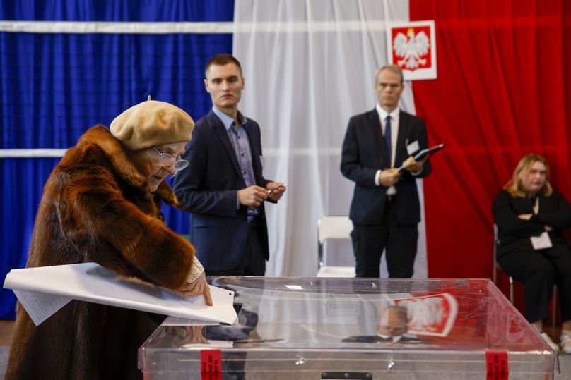 A woman casts her ballot during parliamentary elections in Warsaw, Poland, Sunday, Oct. 15, 2023.