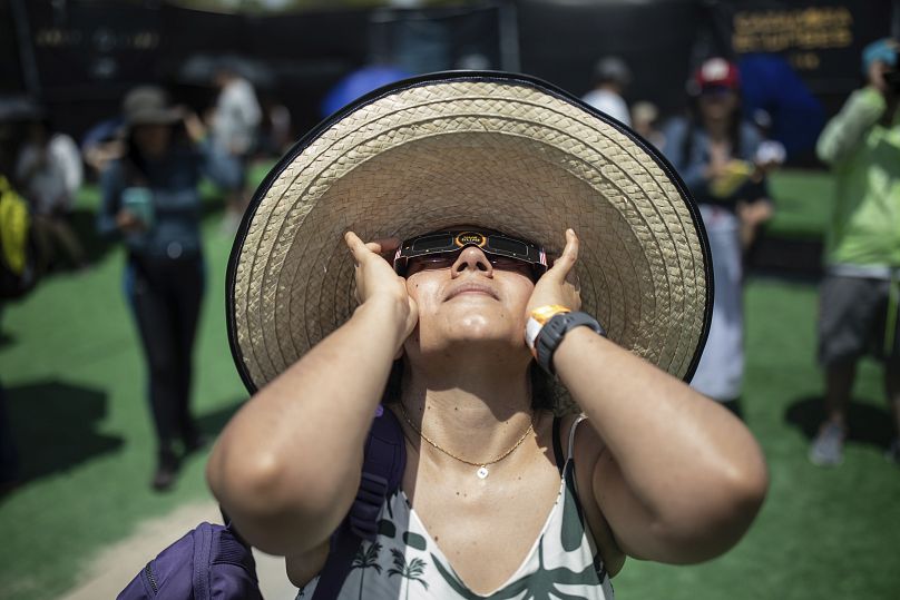 People watch a "ring of fire" solar eclipse in Tatacoa Desert, Colombia, Saturday, October 14, 202
