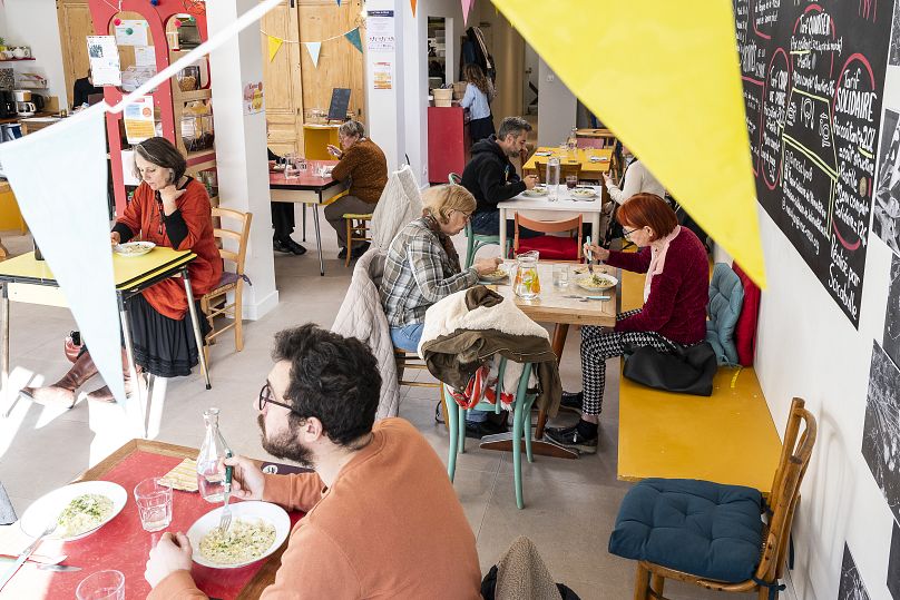 People eat at the canteen of the Maison Engagée et Solidaire de l'Alimentation (MESA) in Lyon 8th, October 2022