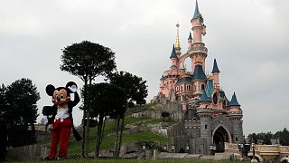  Mickey Mouse poses in front of the castle of Sleeping Beauty at Disneyland Paris, in Chessy, France, east of Paris.