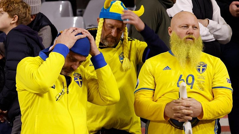 Sweden supporters wait on the stands after suspension of the Euro 2024 group F qualifying soccer match between Belgium and Sweden at the King Baudouin Stadium in Brussels, Mon