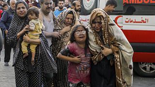 Wounded Palestinians arrive to al-Shifa hospital, following Israeli airstrikes on Gaza City on Monday