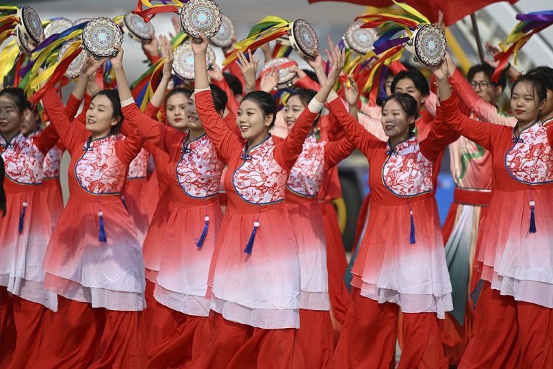 Performers dance as Argentina's President Alberto Fernandez arrives at Beijing's airport ahead of the Belt and Road Forum, October 2023