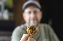 Ed Currie holds up one of his Pepper X peppers, named hottest pepper in the world by the Guinness Book of World Records.