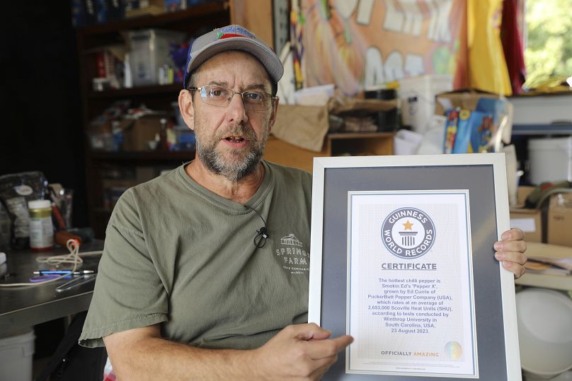 Ed Currie holds up his certification that his new Pepper X variety of peppers is the hottest in the world according to the Guinness Book of World Records.