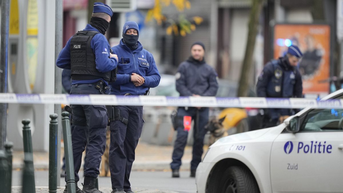 Belgian Police stand behind a cordoned off area close to where a suspected Tunisian extremist has been shot dead hours after manhunt looking for him Tuesday, Oct. 17, 2023. 