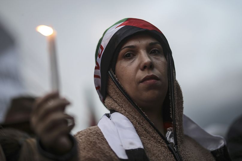 امرأة تحمل شمعة، خلال الوقفة الاحتجاجية لإظهار الدعم للفلسطينيين