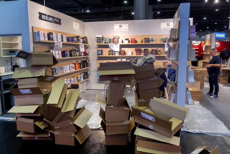 People prepare a booth for the Book Fair in Frankfurt, Germany, Tuesday, Oct. 17, 2023.
