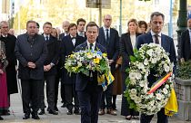 Sweden's Prime Minister Ulf Kristersson, center, and Belgium's Prime Minister Alexander De Croo, center right, carry floral tributes. 18 October 2023
