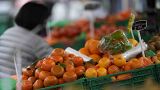 A woman looks at fruit and vegetables on sale at a stall in London, Tuesday, Feb. 28, 2023.