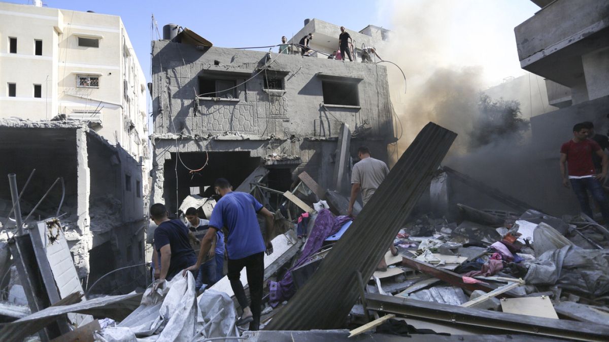 Palestinians look for survivors after Israeli airstrikes in Gaza City, Gaza Strip