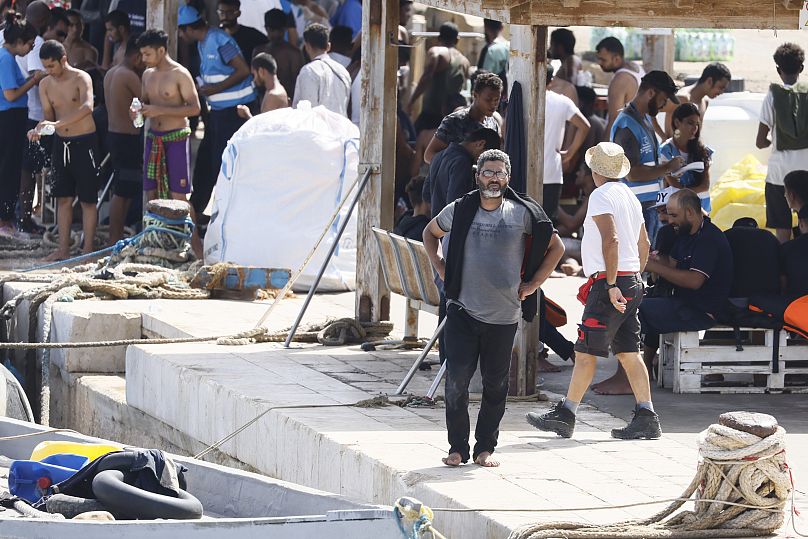 Migrants wait in Lampedusa migrants centre