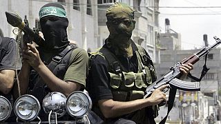FILE - Palestinian militants from Hamas ride on a truck with their weapons  in Gaza City, June 13, 2007.