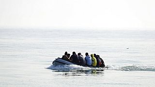 A group of people thought to be migrants arrive in an inflatable boat at Kingsdown beach after crossing the English Channel, near Dover, England