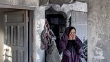 A woman reacts as she stands in a heavily damaged house following Israeli bombardment in Rafah in the southern of Gaza Strip on October 19, 2023.