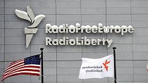 In this Friday, Jan. 15, 2010 file photo, the headquarters of Radio Free Europe/Radio Liberty (RFE/RL) is seen with the United States flag in the foreground, in Prague.