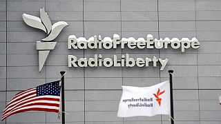 In this Friday, Jan. 15, 2010 file photo, the headquarters of Radio Free Europe/Radio Liberty (RFE/RL) is seen with the United States flag in the foreground, in Prague.