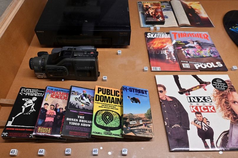 An Canon E440 8MM camcorder, VHS tapes, Vinyl and magazines are displayed at "Skateboard" at London's Design Museum