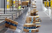 Amazon packages move along a conveyor at an Amazon warehouse facility on Dec. 17, 2019, in Goodyear, Arizona