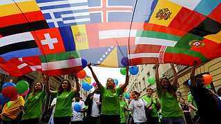 FILE: Young people carry a banner with European countries flags during an annual parade to honour Robert Schumann, whose ideas led to the creation of the European Union.