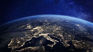 Europe at night viewed from space, with cities illuminated
