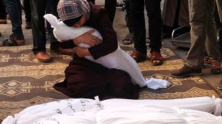 Palestinian Samia al-Atrash holds the corpse of one of her sister's children, killed in an Israeli bombardment in Rafah in the southern Gaza Strip on Saturday