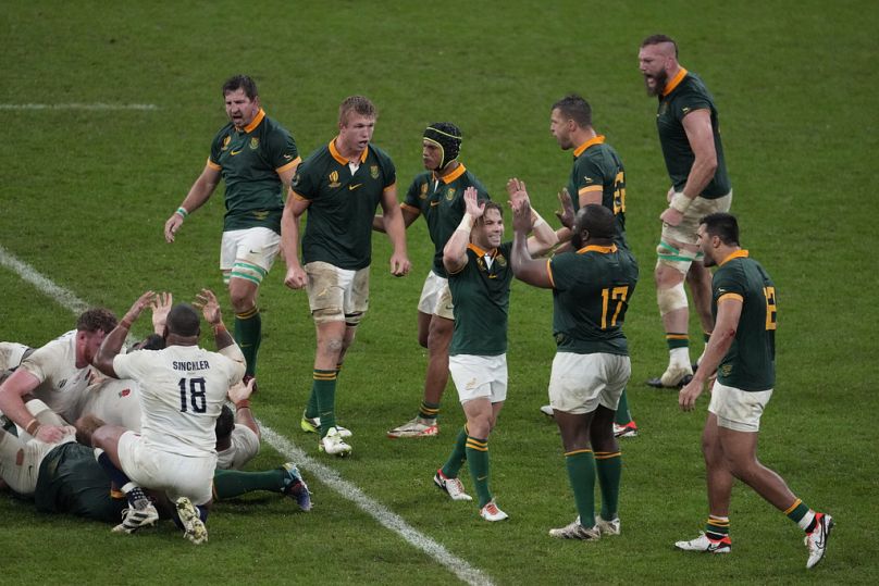 South Africa's Faf de Klerk, centre celebrates with South Africa's Ox Nche at the end of the Rugby World Cup semifinal match between England and South Africa