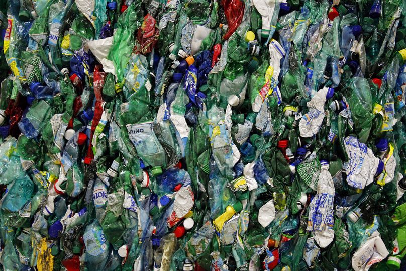 Plastic bottles are compacted at a plant in Paris, December 2015