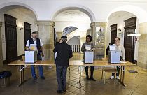 A man casts his ballot during Swiss federal elections in Delemont, Switzerland, Sunday, Oct. 22, 2023. 