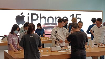 Customers experience iPhone 15 at an Apple store in Shanghai, China, October 7, 2023.