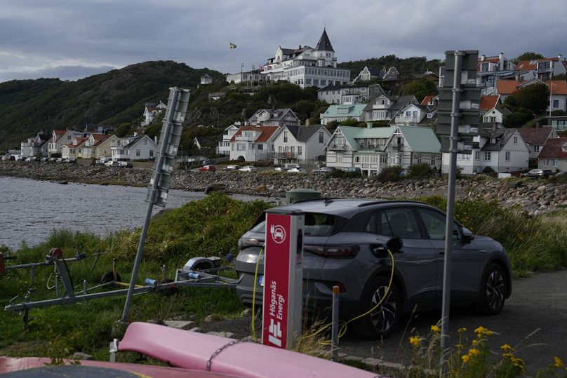An electric car charges on a parking in a harbour of Mölle, south-west Sweden.