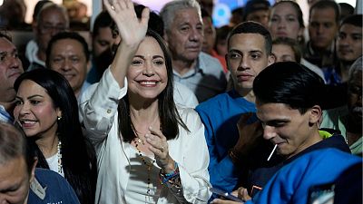 Opposition presidential hopeful Maria Corina Machado celebrates with supporters in Caracas.