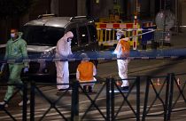 Belgian police officers from the forensic service search for evidence in a street after two people were killed during a shooting in Brussels on October 16, 2023.