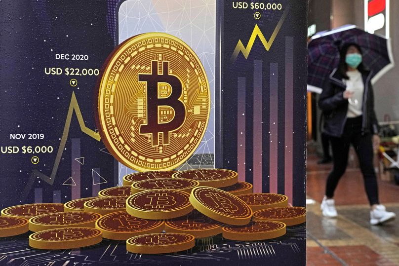 An advertisement for Bitcoin cryptocurrency is displayed on a street in Hong Kong, February 2022