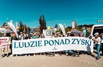 Climate campaigners in Poland are demanding a just transition from coal. Their banner reads “People over Profit.” 